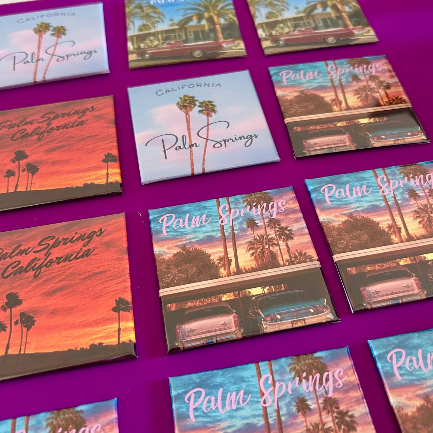Collection of 'Palm Springs, California' themed fridge magnets on a purple background
