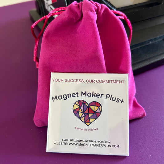 Example of business card magnet showing on velvet pink bag.