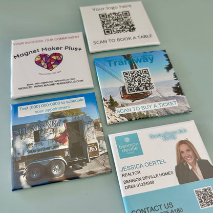 Collection of promotional business card magnets with QR codes on a gray background