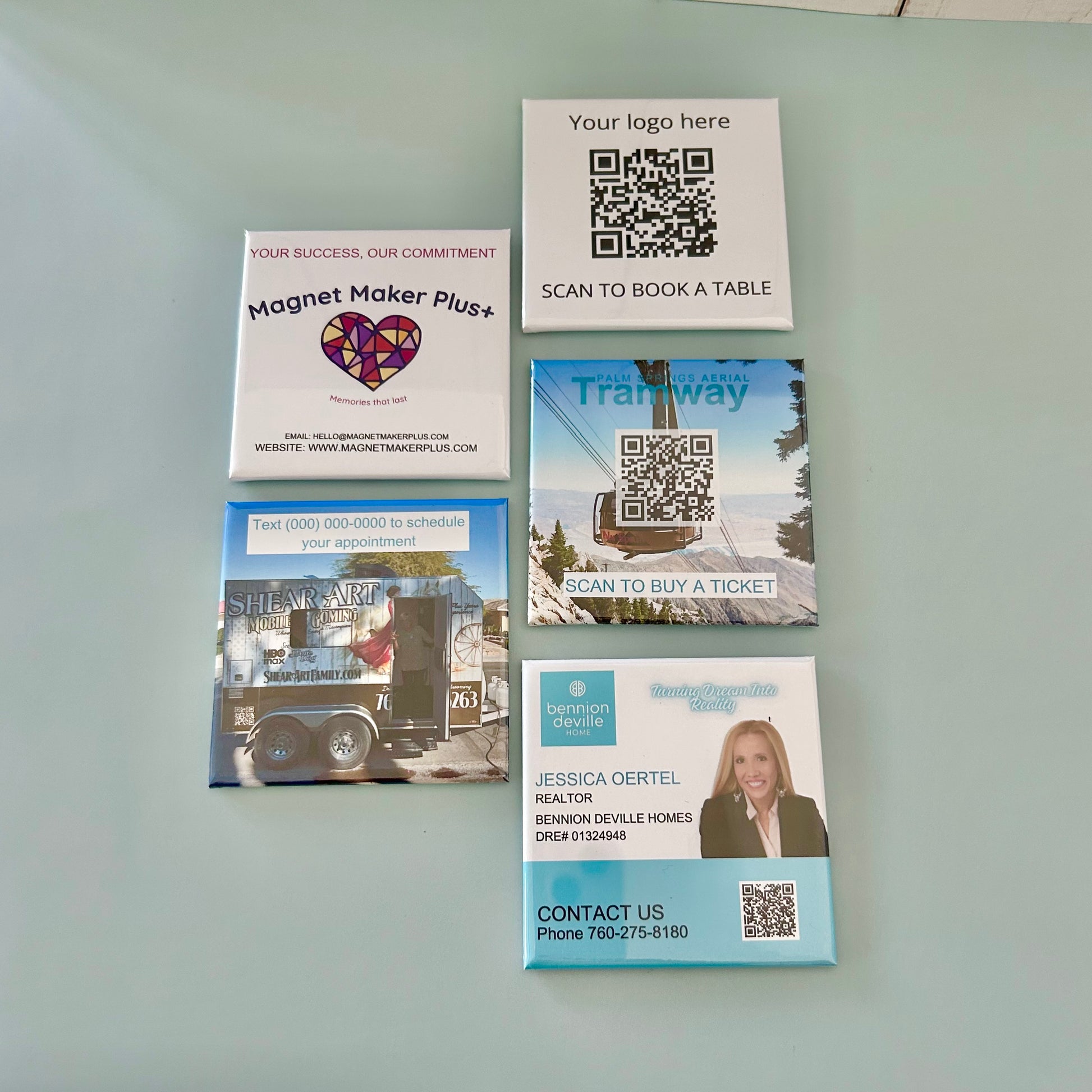 Collection of promotional card magnets with QR codes on a light gray background