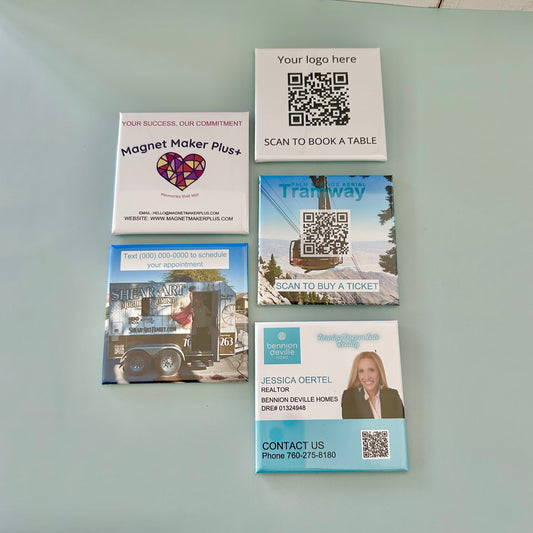 Collection of promotional card magnets with QR codes on a light gray background