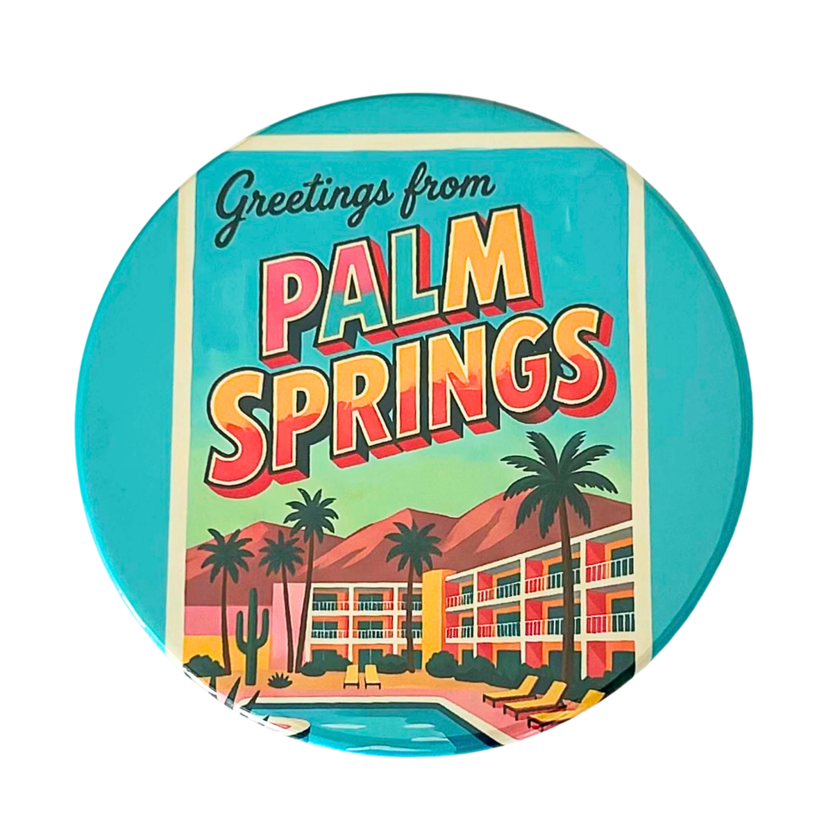 Greetings from Palm Springs round coaster featuring vintage postcard lettering, a turquoise pool, yellow loungers, palm trees, a colorful hotel, and desert mountains.
