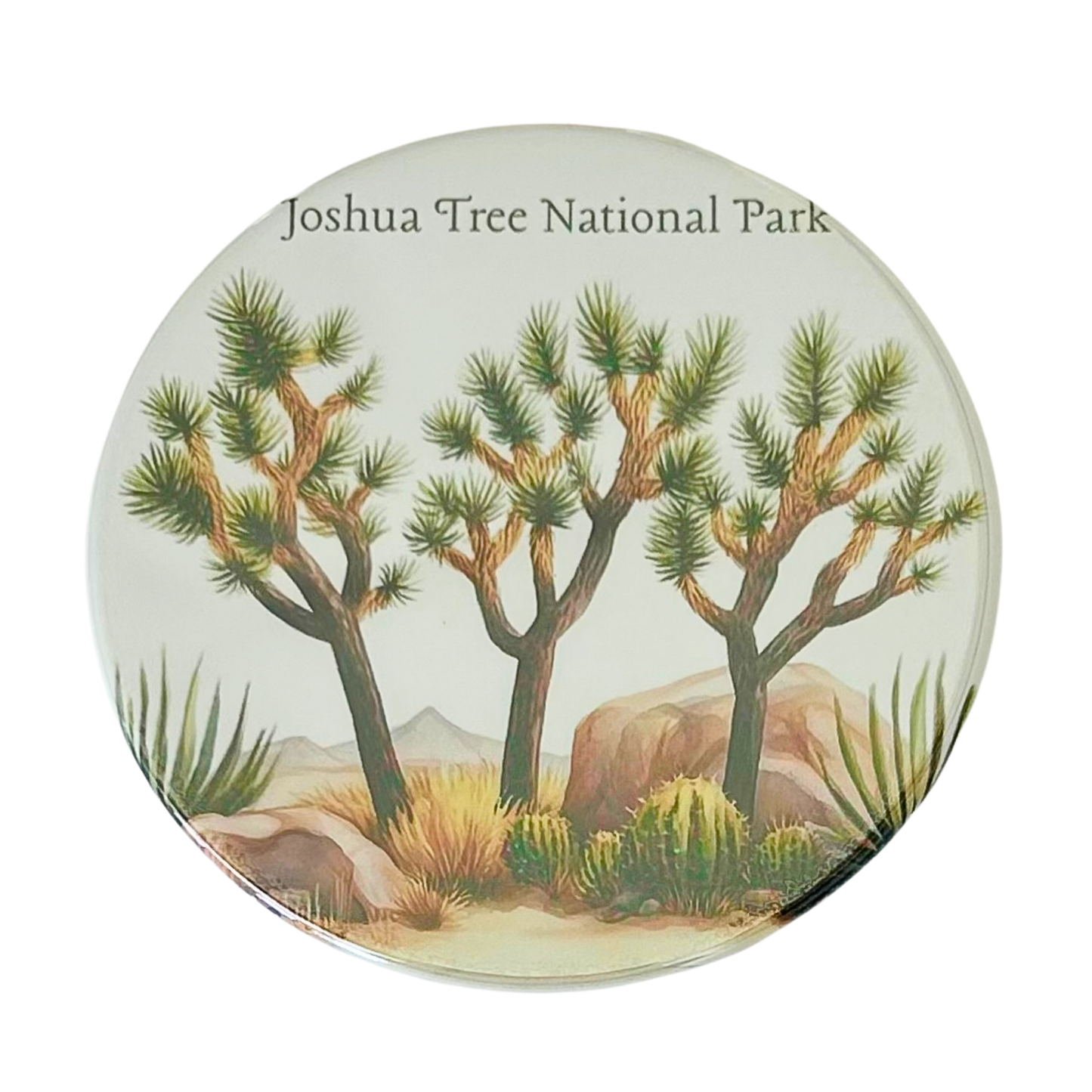 Square coaster featuring a watercolor illustration of three Joshua trees with agave plants, desert scrub, and boulders under the text "Joshua Tree National Park."

