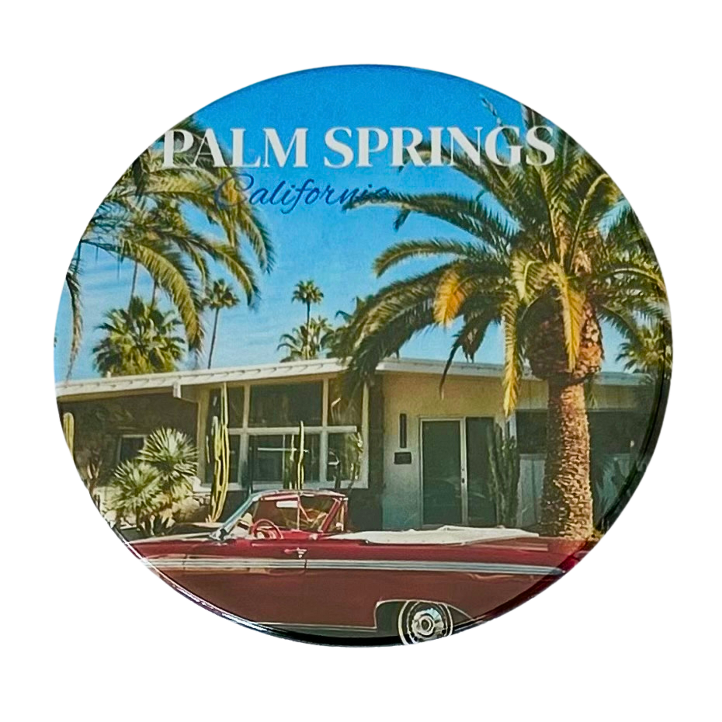 Round 3.5" Palm Springs California coaster featuring a red vintage convertible parked in front of a mid-century modern home with towering palm trees and a brilliant blue sky.