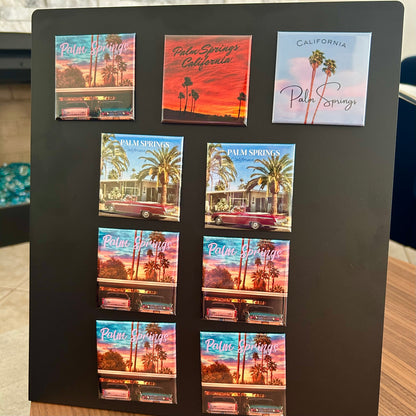 Collection of Palm Springs-themed magnets displayed on a black magnetic stand.