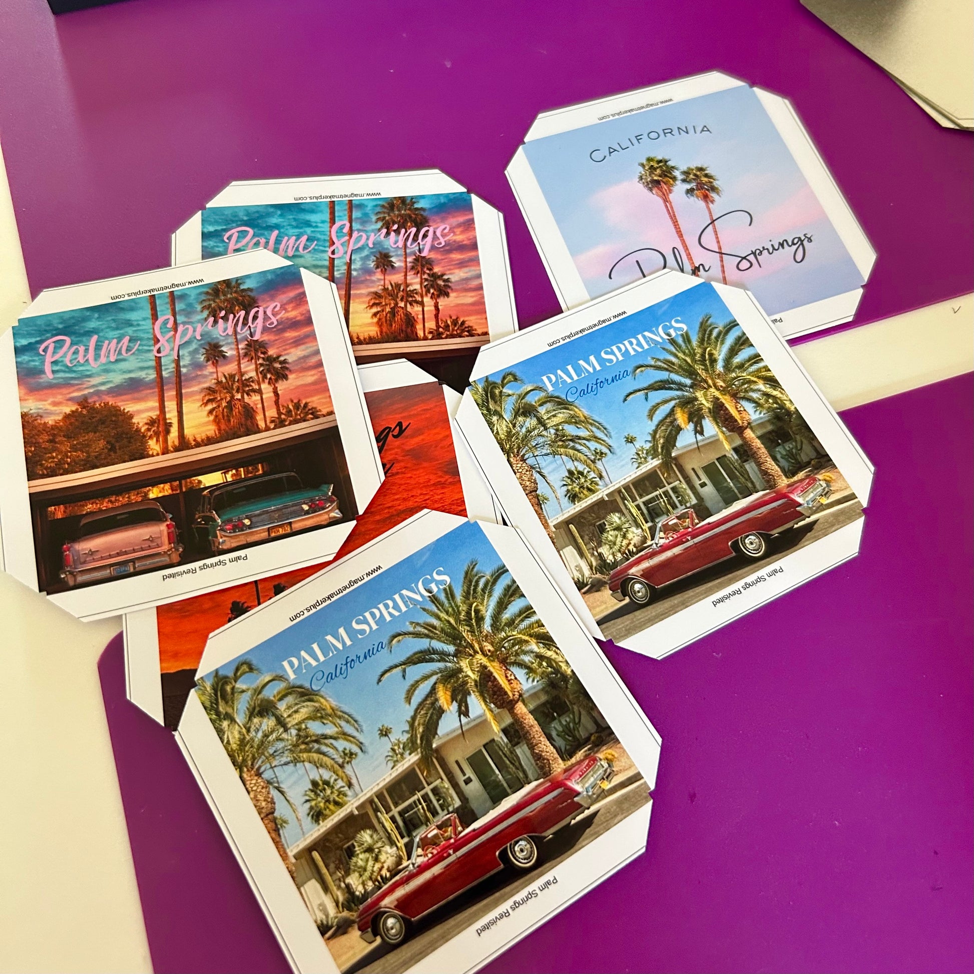 Set of magnets with Palm Springs-themed designs on a purple surface