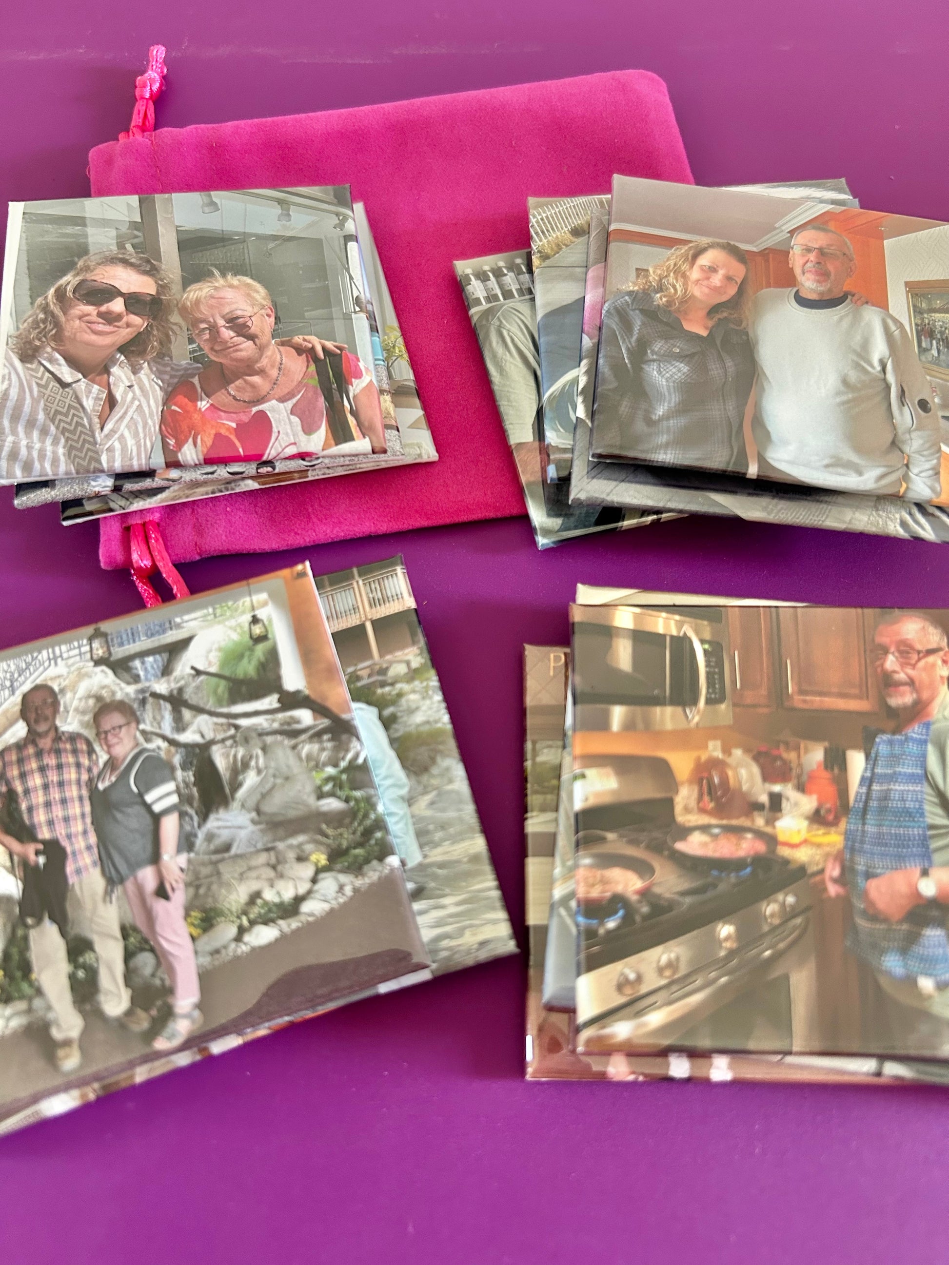 Collection of photo travel fridge magnets on a purple surface
